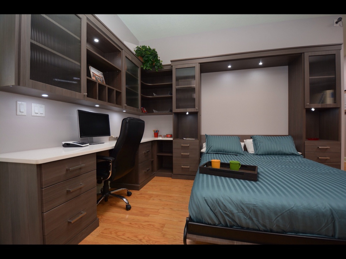 A home office featuring custom storage and a Murphy bed.