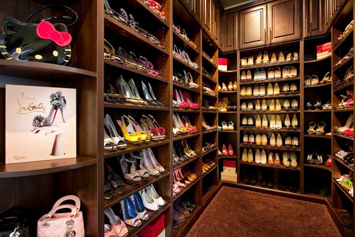A spacious walk-in closet section dedicated to designer footwear.